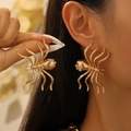 Gothic gold spider earrings with white rhinestones on model for a bold fashion look - KC Gold Style (KC Gold DZ-937)