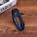 Close-up of blue and black braided leather bracelet with black metal cross and magnetic clasp - Blue