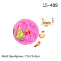 Pink silicone Christmas mold featuring reindeer, Santa, and tree shapes for DIY baking - Pink