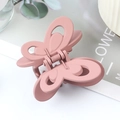 Elegant matte pink butterfly hair claw clip for women featuring hollow wing design - Rubber Pink