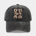Detail of grey washed canvas baseball cap featuring leopard print embroidered letter H - Letter H