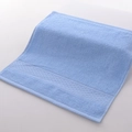 Light blue pure cotton towel with soft looped texture and decorative woven border - 34x34cm / Star Blue