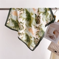 Floral print silk square scarf draped on a metal rod showing smooth texture and green border - 66-70cm / Green (FJ967-6)
