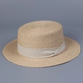 Detail of raffia boater hat showing woven texture and cream ribbon on grey background - M (56-58cm Adjustable) / Beige Ribbon
