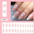 Detail view of W957 almond fake nails featuring nude pink finish with white hearts and silver glitter - W957 Glitter Heart