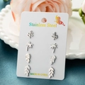 Detail view of 4 pairs of silver stainless steel studs featuring palm and leaf designs - Steel