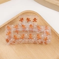 Transparent square hair claw clip featuring gingerbread man and white star patterns - Gingerbread Man