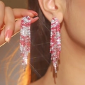 Elegant pink and silver long tassel earrings with sparkling rhinestones worn by a model - Flat Style / Pink and Silver Pattern