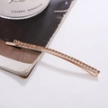 Detail of rose gold hair clip with champagne crystals on a magazine background - Rose Gold Base Yellow Crystal