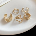 Detail of five gold geometric open rings with hammered and twisted textures on a ceramic tray - Golden Irregular Geometric Style (Set of 5)