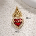 Macro shot of 22mm gold-plated red enamel sacred heart pendant with stones and flame detail - R002-Flame Heart