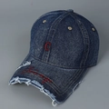 Close-up of red C embroidery and Chicago script on distressed blue denim baseball cap - Denim Blue