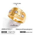 Detail of 18K gold plated stainless steel ring with three grey pearls and irregular texture - Gold