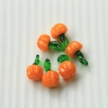 Detailed view of orange glass pumpkin charms with green loops for jewelry making - 56# Orange/Pumpkin