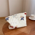 Detailed close-up of quilted cotton cosmetic bag with bear print and branded label - Big Bear