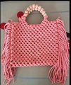 Pink woven bohemian mini bag with wooden bead handle and decorative side tassels - Pink