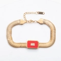 Detailed macro view of 18k gold plated stainless steel bracelet with red stone and zircon - Red
