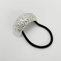 Close-up of textured silver curved alloy accent on black elastic hair tie on white background - Sand Silver Type 1