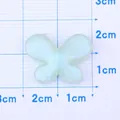 Sparkly light green resin butterfly charm measuring 2cm for DIY jewelry making - Green