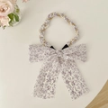 Elegant purple floral pearl headband with large bow ribbon displayed with roses - White Purple Floral