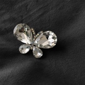 Golden butterfly brooch with faceted clear crystals and small colorful diamonds - White