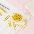 Yellow macaron paper clips in a transparent storage box on a pastel stationery desk - Yellow