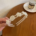 Elegant sponge headband with white pearls and roses on a natural wooden table background - Pearl Rose Style / White