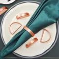 Modern rose gold D-shaped metal napkin rings with a brushed finish on a white plate - Zinc Alloy / Matte Rose Gold D-Shape