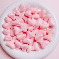 Detailed view of pink iridescent bow-shaped beads for DIY jewelry and phone charms - Sold per piece / Pink