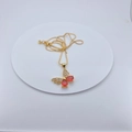 Detailed close-up of gold-plated butterfly pendant with red crystals and micro-inlaid zircons - Pendant Necklace / Red Butterfly