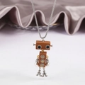 Detailed view of robot pendant with gear eyes and Eiffel Tower legs on silver chain - Bronze