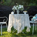 Elegant white lace tablecloth with floral patterns and ruffled edges on a round table - 140*140cm / White Round Mirror Flower (Ruffled)