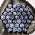 Detailed macro view of 25mm natural blue sodalite crystal spheres in a black display tray - 25mm No Hole Sphere / Blue Spot Stone