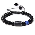 Cancer zodiac braided bracelet with black beads and a blue accent on white background - Cancer