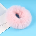 Minimalist soft pink plush hair tie for bun hairstyles on a light blue background - Pink