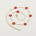 Golden stainless steel necklace featuring red flower beads and small round gold accents - Red Necklace