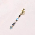 Detailed view of a gold snake-patterned ear cuff with hanging blue crystal pendants - Brown Short Style E9321