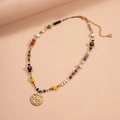 Detail of beaded necklace with textured gold coin pendant and colorful rhinestones - Multi-color Moon Star Round Style