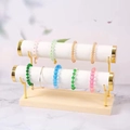 Double-layer jewelry display stand with white rolls and golden metal support - 2-Tier White Leather