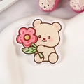 Cute acrylic bear brooch pin holding a pink flower on a white heart tray - Flower Bear