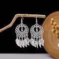 Detail of silver bohemian earrings with hollow leaf tassels hanging on a wooden branch - Silver Ring Dreamcatcher Hollow Leaf Style (E2873-36)