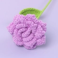 Handmade purple crochet rose with green leaves on a pastel lilac background - Sharp Corner Rose-Purple