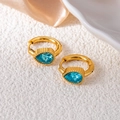 Close-up of teardrop blue crystal earrings with vintage gold-tone textured metal bands - Water Drop Zirconia / Light Blue