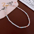 Detailed macro view of the gold lobster clasp and adjustable extension chain on the necklace - Light Blue