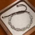 Detail of hand-woven retro ethnic bracelet featuring engraved silver elephant beads - 8 Elephants Bracelet