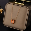 Rose gold H-shaped necklace with orange enamel pendant on a brown jewelry gift box - Pop H Style (8803) / Rose Gold with Orange