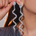 Elegant long silver snake earrings with sparkling rhinestones worn on a model side view - Silver Snake Rhinestone (DTE1816350S)