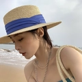 Detail of summer straw sun hat with blue ribbon and beige woven bag on the beach - M (56-58cm) / Beige Fedora-Royal Blue Ribbon
