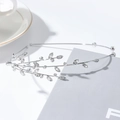 Detailed view of silver leaf branch headband featuring sparkling crystal rhinestones - Leaf Silver