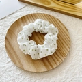 Chic white scrunchie with green polka dots on a wooden tray for elegant hair styling - White Green